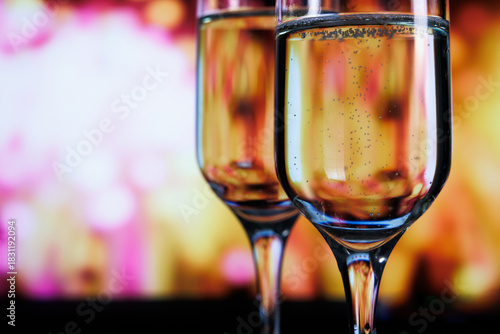 Two glasses of champagne against a backdrop of fireworks