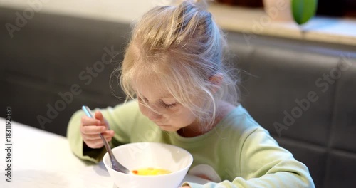 Girl enjoying lunchtime at Restaurant, a cozy place with tasty soup, eating alone on a cloudy day in Amsterdam