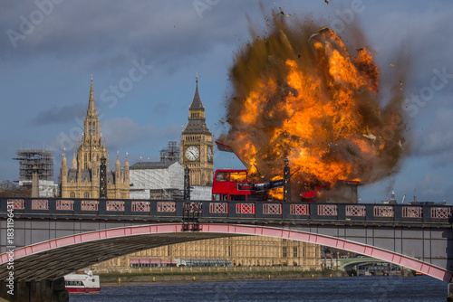 LONDON, UK -  7 2016.  A dramatic scene unfolds as a red double-decker bus explodes on Lambeth Bridge, with the iconic Parliament buildings in the background. 