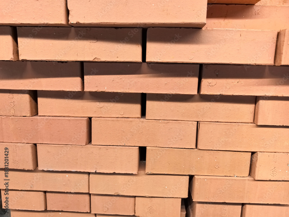 Fototapeta premium Stacked bricks ready for construction at a building site in daylight