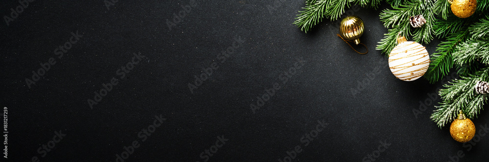 Obraz premium Christmas decorations and spruce tree at black background.