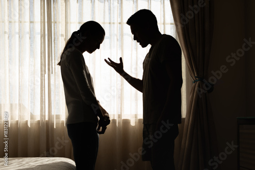 Couple Arguing in Silhouette Near Window