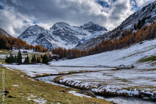 Autumnal winter atmosphere in the Davos area. Sertig Valley. Beautiful autumn colors and already snow-covered mountain peaks. . High quality photo