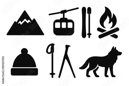 Silhouette of mountains with cable car and ski equipment against a sunset sky