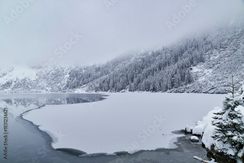 Fototapeta Naklejka Na Ścianę i Meble -  Morskie Oko Lake Covered in Ice at Winter in Tatra Mountains Poland.