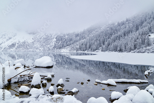 Fototapeta Naklejka Na Ścianę i Meble -  Morskie Oko Lake Covered in Ice at Winter in Tatra Mountains Poland.
