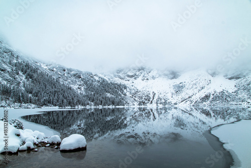 Fototapeta Naklejka Na Ścianę i Meble -  Morskie Oko Lake Covered in Ice at Winter in Tatra Mountains Poland.