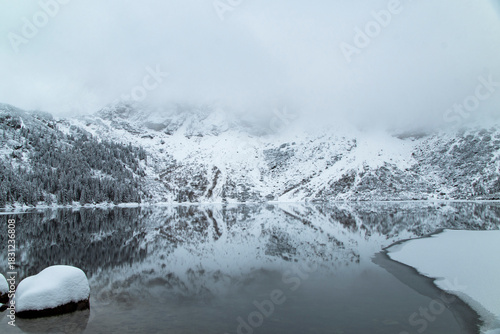 Fototapeta Naklejka Na Ścianę i Meble -  Morskie Oko Lake Covered in Ice at Winter in Tatra Mountains Poland.