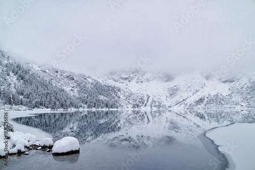Fototapeta Naklejka Na Ścianę i Meble -  Morskie Oko Lake Covered in Ice at Winter in Tatra Mountains Poland.