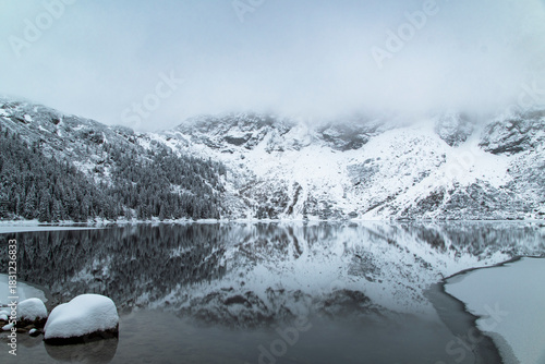 Fototapeta Naklejka Na Ścianę i Meble -  Morskie Oko Lake Covered in Ice at Winter in Tatra Mountains Poland.