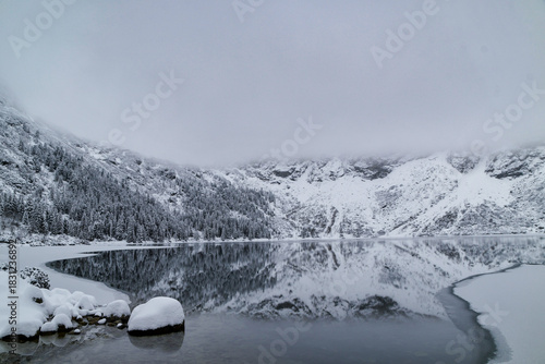 Fototapeta Naklejka Na Ścianę i Meble -  Morskie Oko Lake Covered in Ice at Winter in Tatra Mountains Poland.