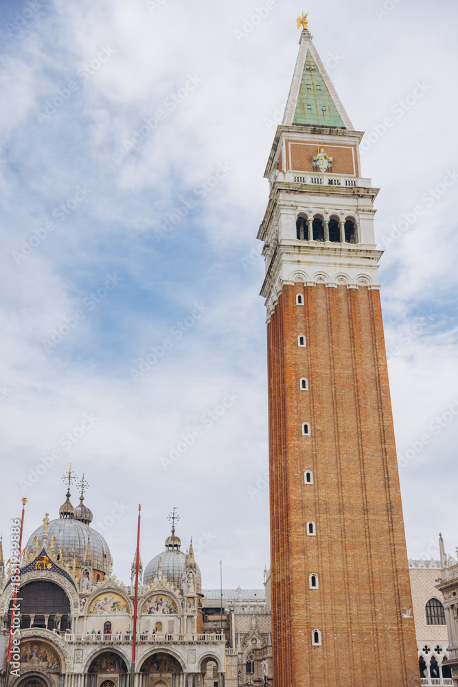 Naklejka premium St. Mark's Campanile towering over buildings in Venice Italy