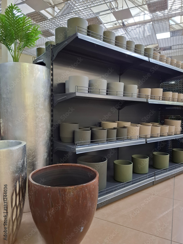 Fototapeta premium Ceramic flower pots on supermarket shelves. Ceramic products in flower shop