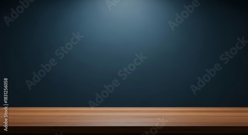 Empty wooden table with dark blue wall and spotlight background