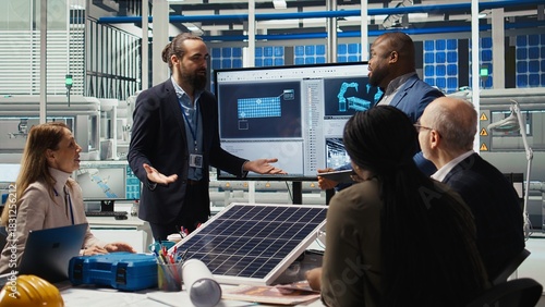 Fotografija Businesspeople celebrating successful investments in solar energy, dancing in factory office