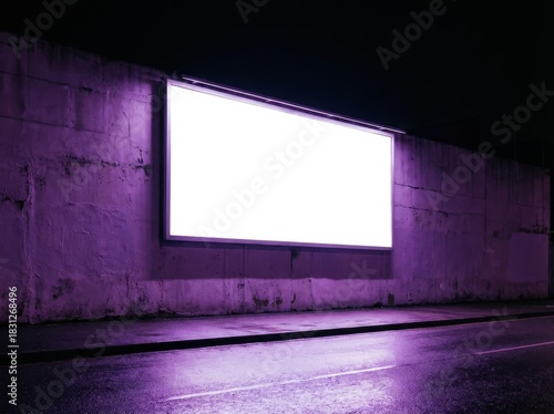 Blank billboard on a concrete wall at night with purple lighting.