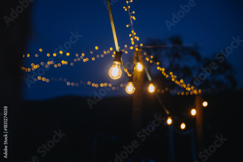 String lights illuminating evening sky during holidays