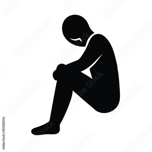 Silhouette figure sitting alone hunched over representing deep sadness loneliness and mental distress