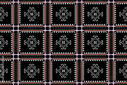 Black tribal geometric textile with white linear motifs and grid framing, combining minimal elegance with traditional heritage.