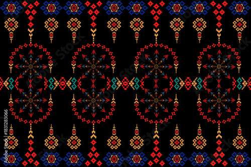 Black tribal geometric textile with red, blue, and gold motifs in symmetric arrangement, reflecting cultural richness and crafted elegance.