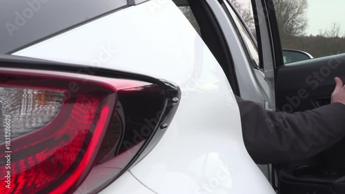 Male Passenger Exiting Car's Back Seat Exterior View