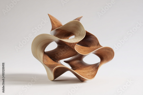 Intricate wooden sculpture showcasing flowing forms and elegant curves in a minimalist setting