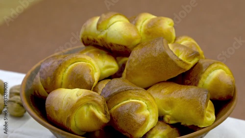buns in a rustic clay pot. national bakery product is a staple during Ukrainian national holiday celebrations.