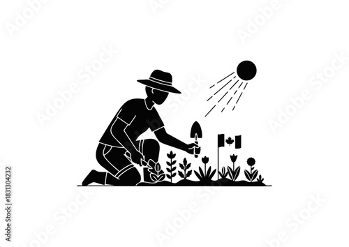 A person in a hat tends to a flower bed with a small trowel under the bright sun, a Canadian flag planted among the flowers