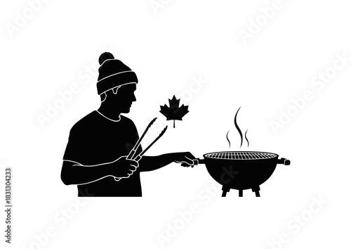 Silhouette of a person in a beanie grilling a maple leaf on a barbecue
