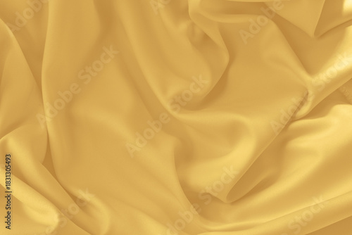 Gold silk fabric background with folds.Copy space.