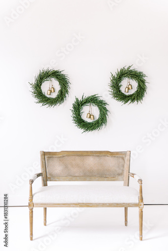 Minimalist Christmas Greenery Wreaths with Gold Bells on White Wall Holiday Decor