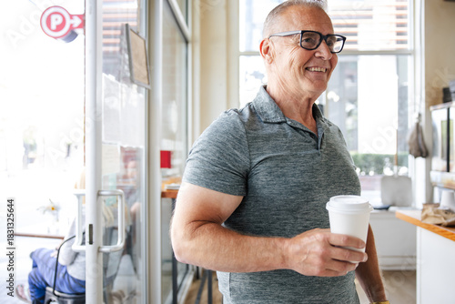 Smiling man with coffee cup indoors