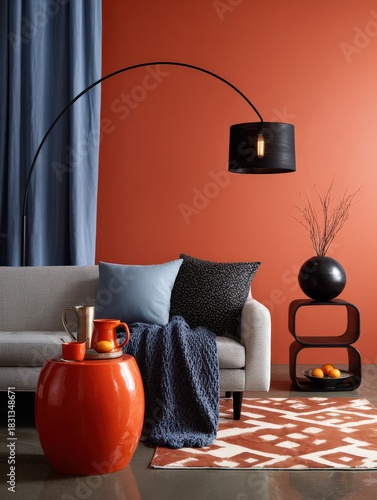 Modern living room with burnt orange wall, grey sofa and blue accents