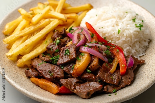 Lomo saltado traditional peruvian stirfry with beef, french fries, white rice and vegetables