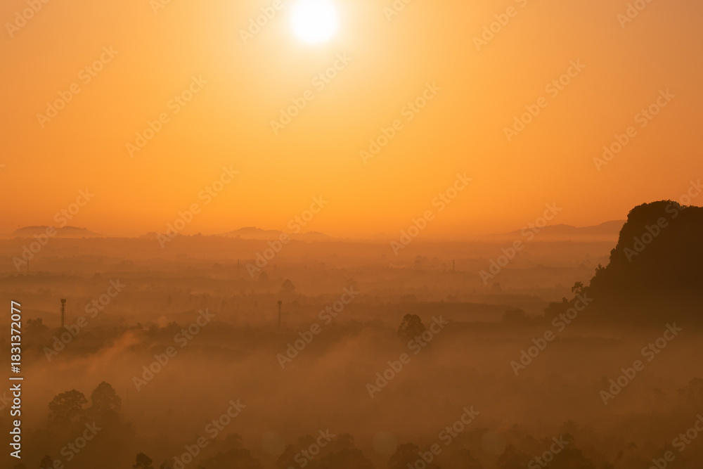 Obraz premium Aerial view of golden morning light and mountains.
