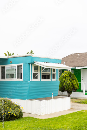 Colorful vintage blue mobile home exterior with nobody 