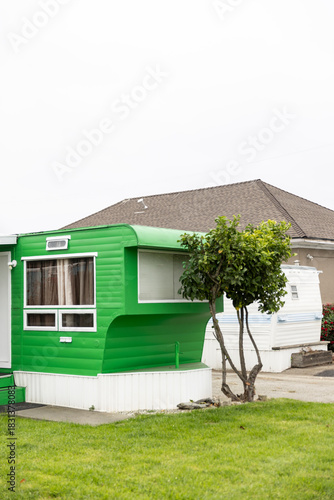 Colorful green vintage  mobile home exterior with nobody 