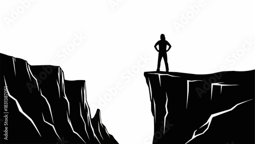 Silhouette of a person standing on a cliff edge looking across a chasm.