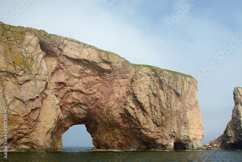 Percé Rock natural formation cliff with a hole at the bottom