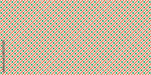 Christmas abstract seamless pattern. Red and green diagonal stripes background. Candy cane repeating decoration modern abstract art design