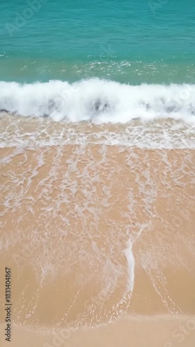 Ocean waves gently washing sandy beach, summer sea vacation coast nature scene, vertical 9:16 mobile wallpaper background