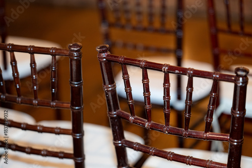 Image of the back of chairs at a wedding ceremony.