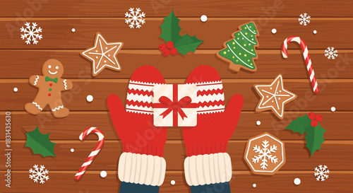 Hands in red mittens holding a Christmas gift, surrounded by festive gingerbread cookies, candy canes, and holly on a wooden table, with falling snowflakes.