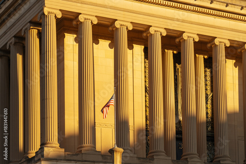 Classical building columns with American flag at golden hour