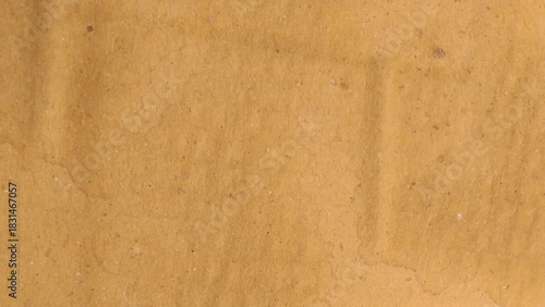 Crumpled brown paper texture. Abstract beige background with wrinkled cardboard texture. 