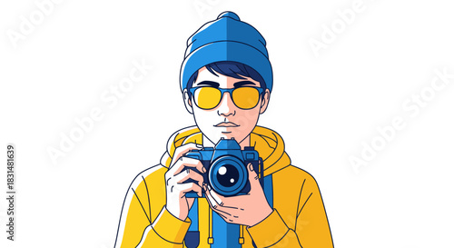 A stylish young man wearing a blue beanie and yellow sunglasses, holding a modern digital camera, ready to capture moments with a keen eye for photography.