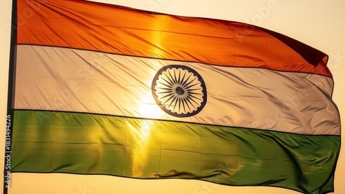 Indian national flag waving against a bright sunset sky