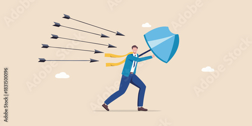 Businessman defends against incoming arrows with a shield