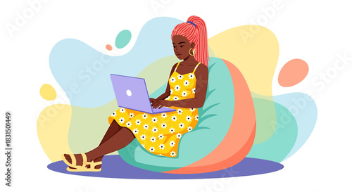 A young woman with vibrant pink hair wearing a yellow dress and sandals, comfortably sitting on a beanbag chair and working on her laptop, with a colorful abstract background