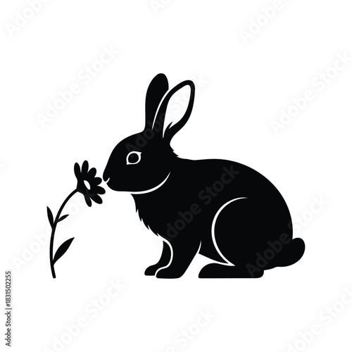 Black rabbit smelling spring flower silhouette vector icon